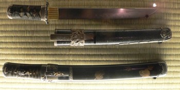Two classical Tanto, with wrapped hilts: the top knife has a straight spine and a small guard; the bottom knife has no guard, and probably a slightly curved spine